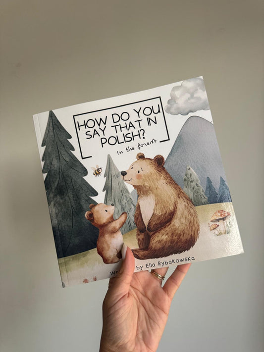Bilingual Polish-English children's book In the Forest open showing woodland animal vocabulary