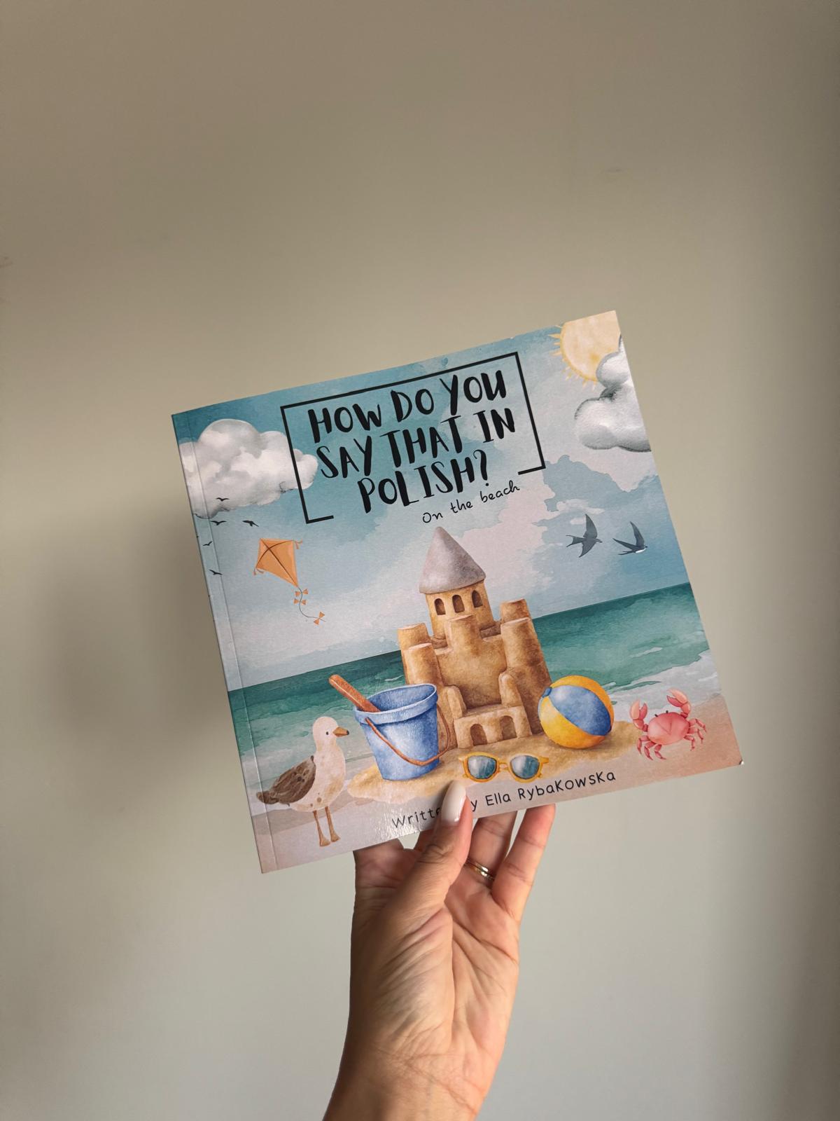 Bilingual Polish-English children's book On the Beach open showing beach vocabulary pages