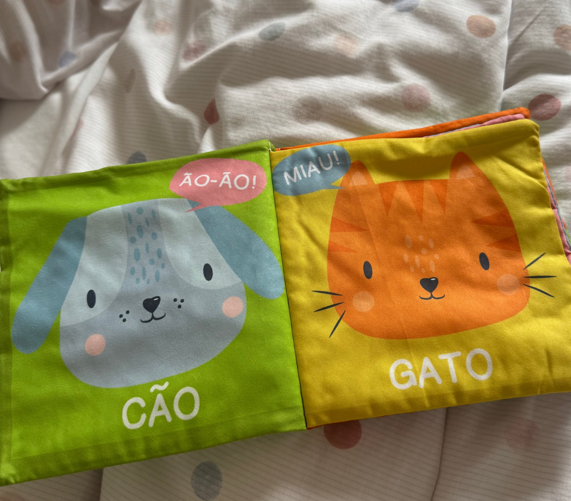Children's book with animal illustrations and text on a polka dot blanket